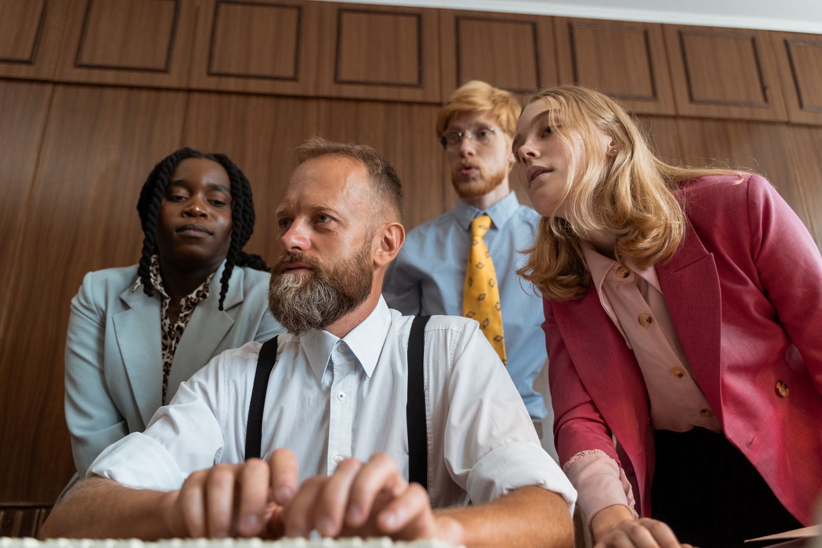 Colleagues collaborating at a computer in an office