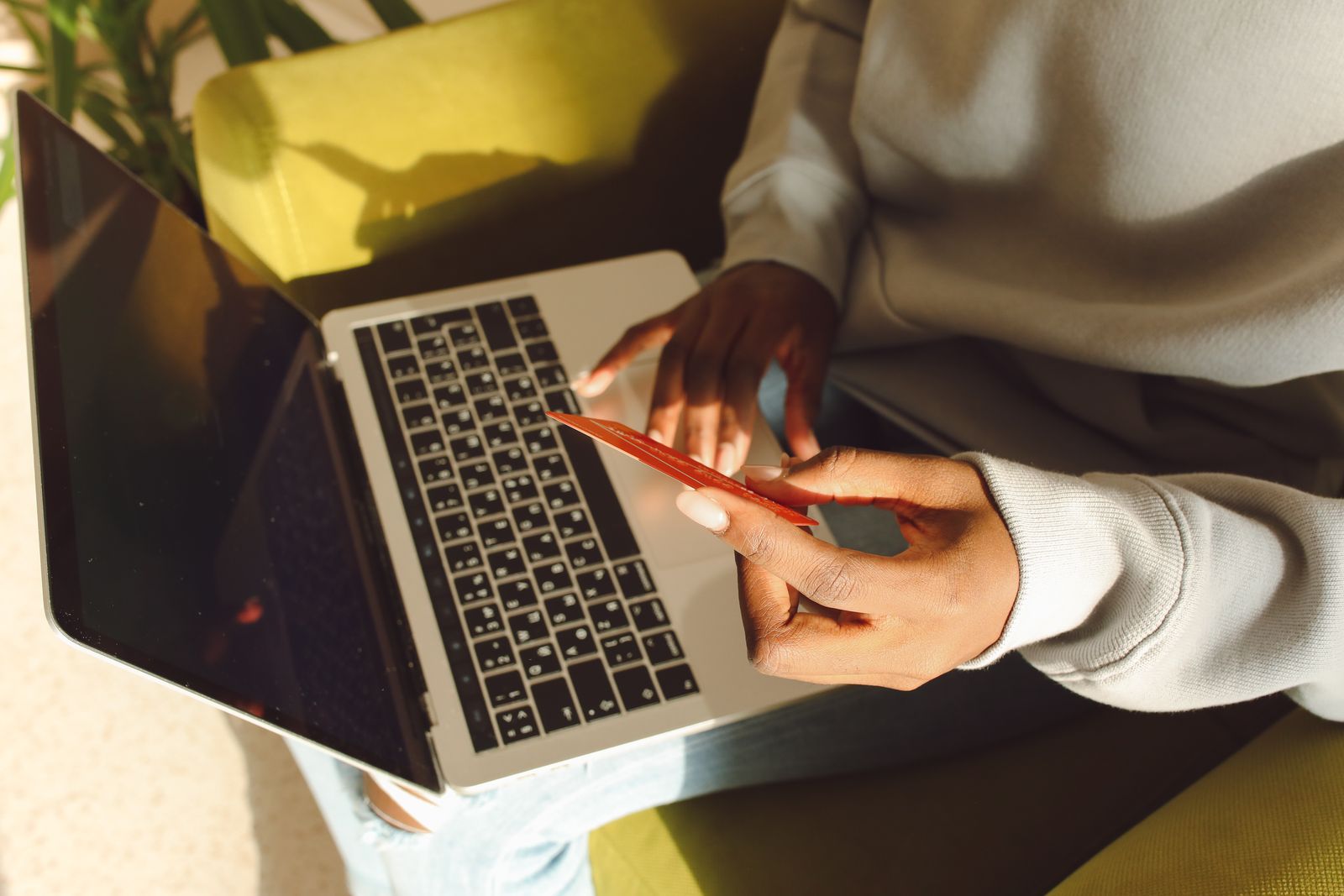 A customer shopping online with a laptop and payment card